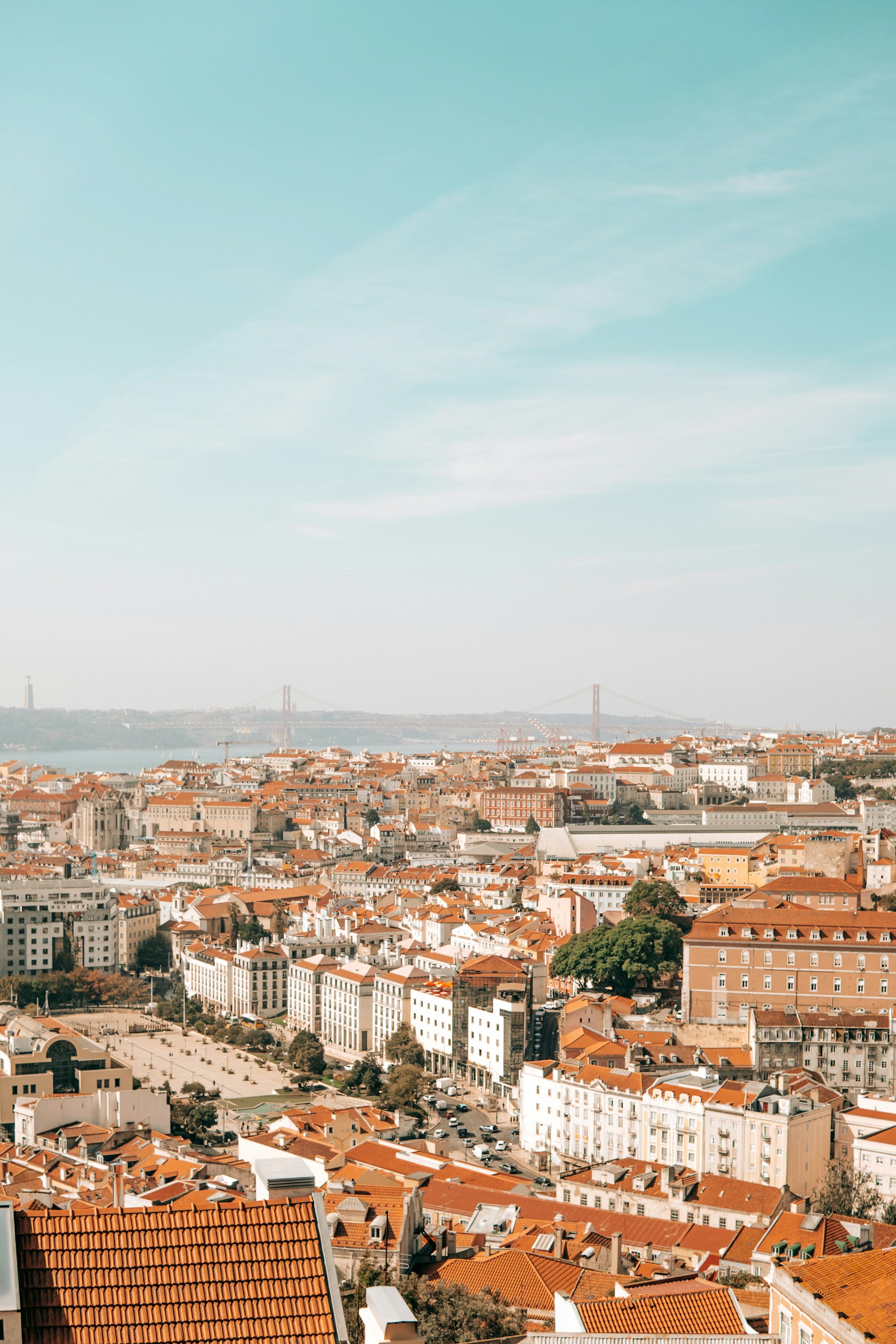 Lisbon's sunlit waterfront and terracotta rooftops